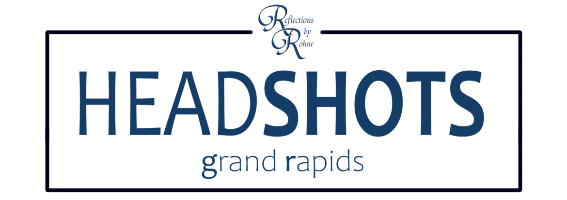 Logo for "rhetorical redhead headshots grand rapids" featuring stylized text on a dark background.